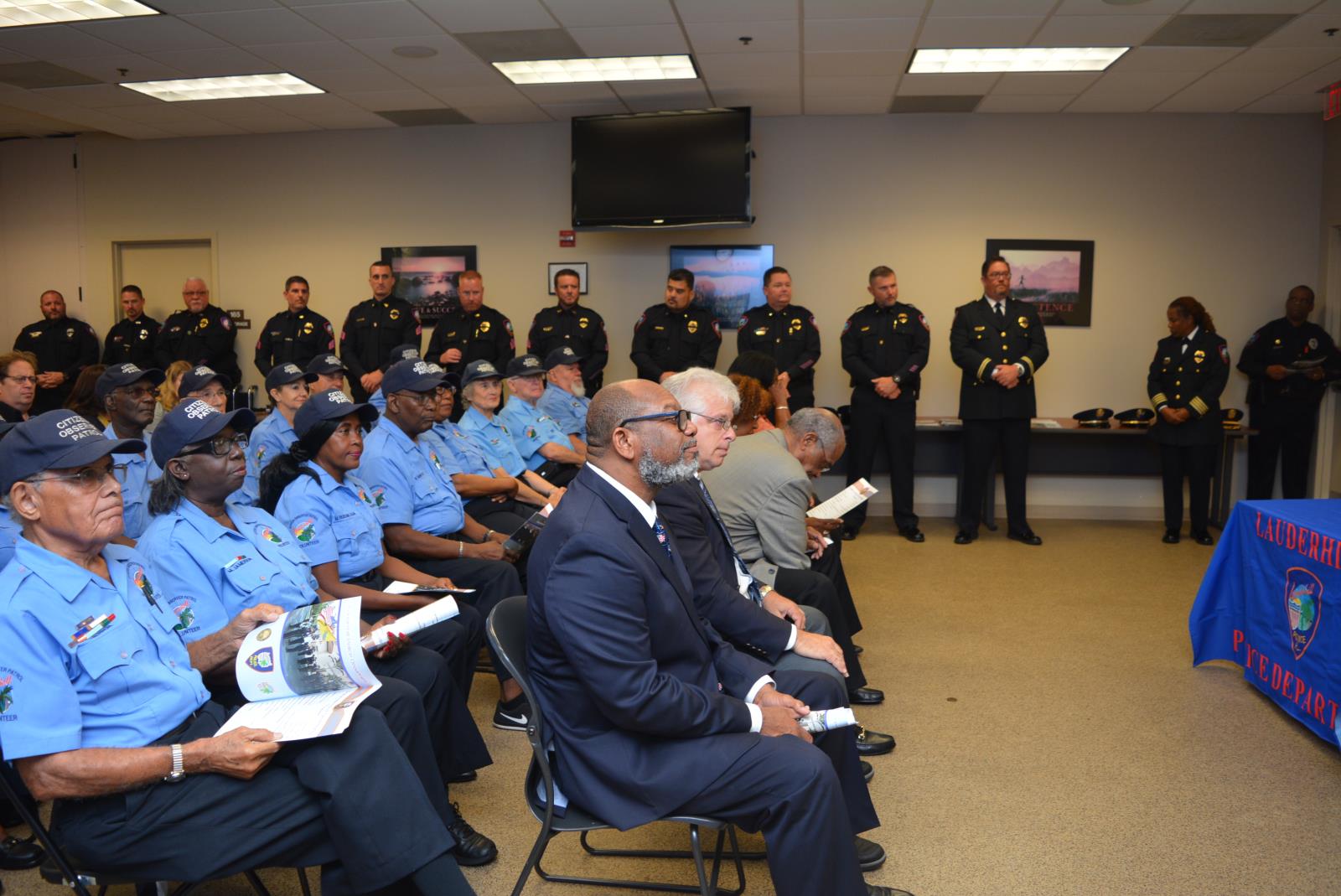 Commissioners Thurston, Berger & Benson with COP volunteers watch the ceremony.