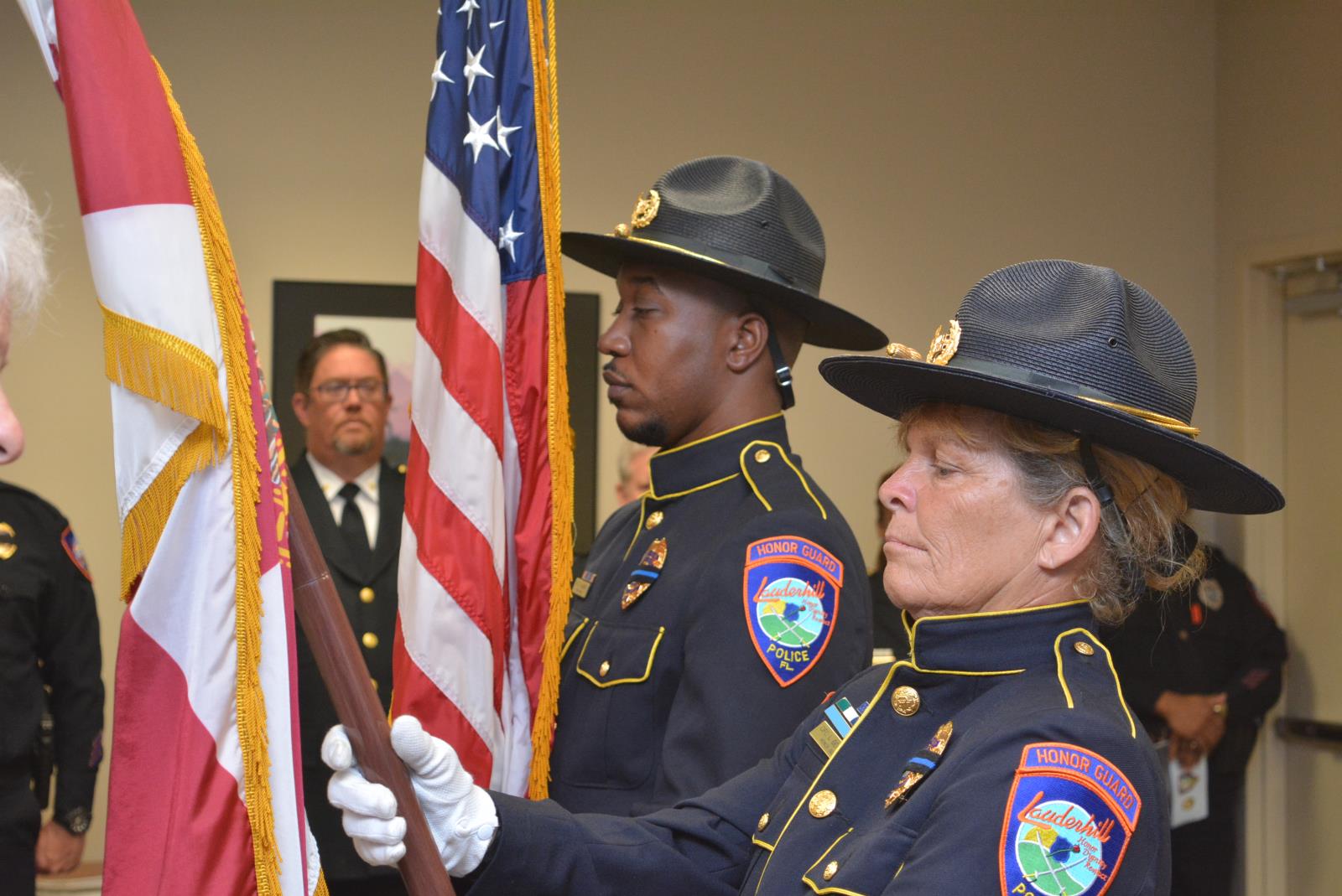 Officers McGriff & Geronimo holding the flags