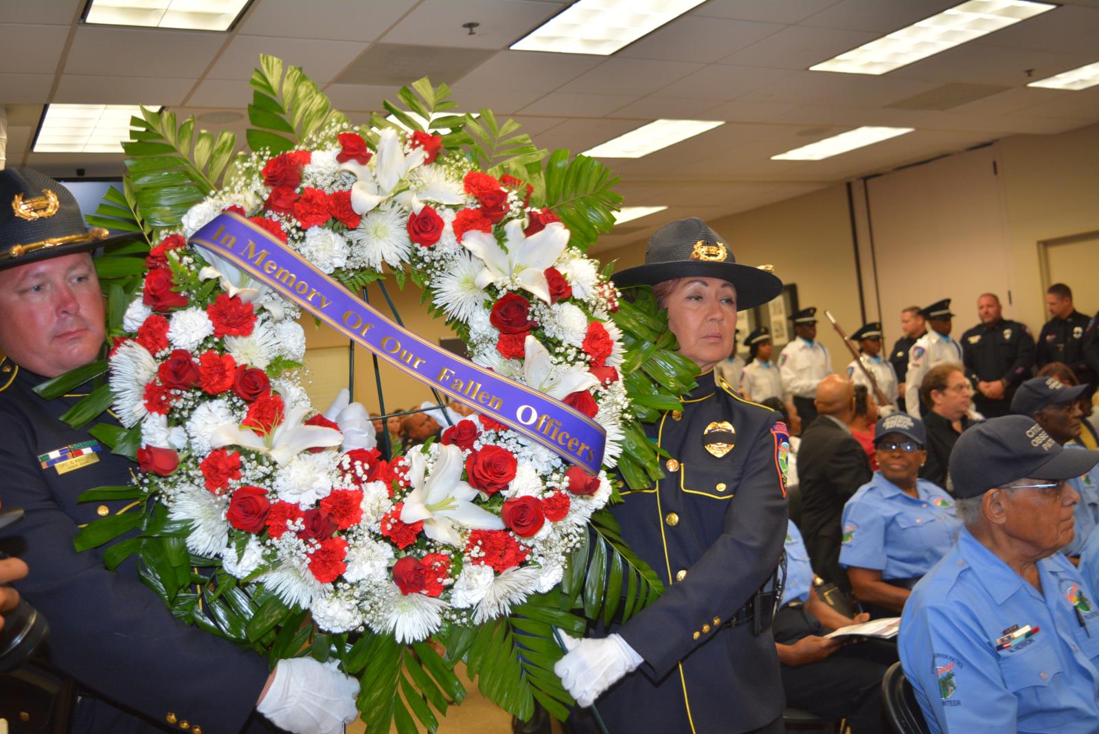 Officers carry Fallen Officer Wreath