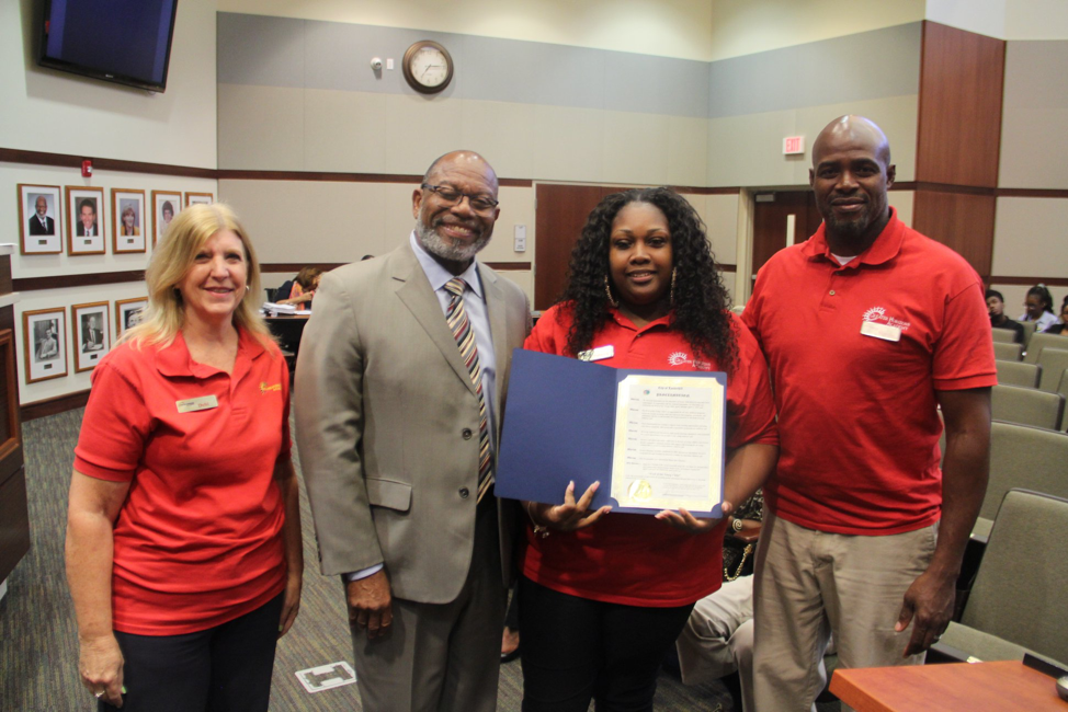 Mayor Ken Thurston presenting the Proclamation to Greater Horizons Academy staff