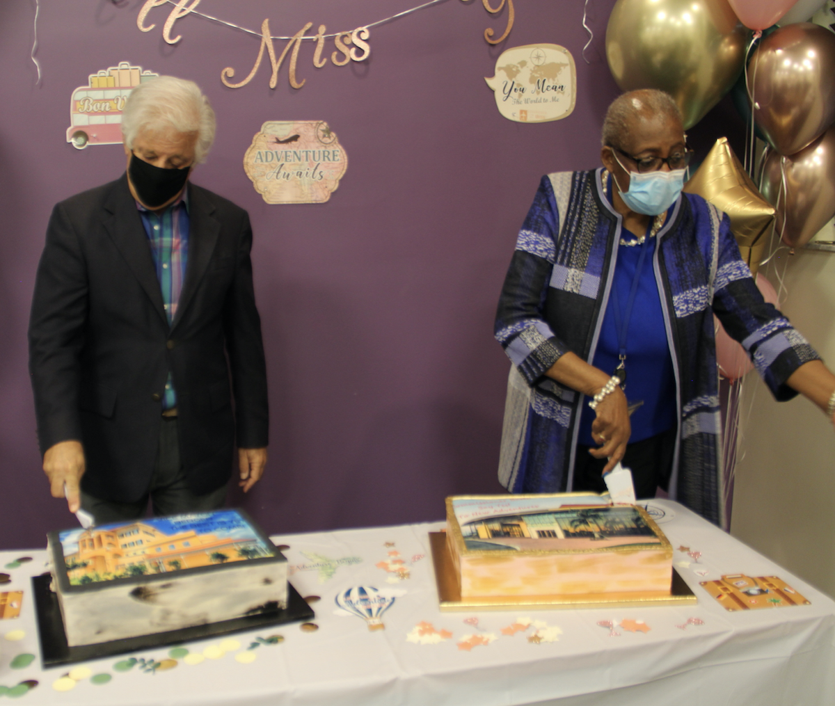 Bates and Berger cut into their farewell cakes at a table with balloons