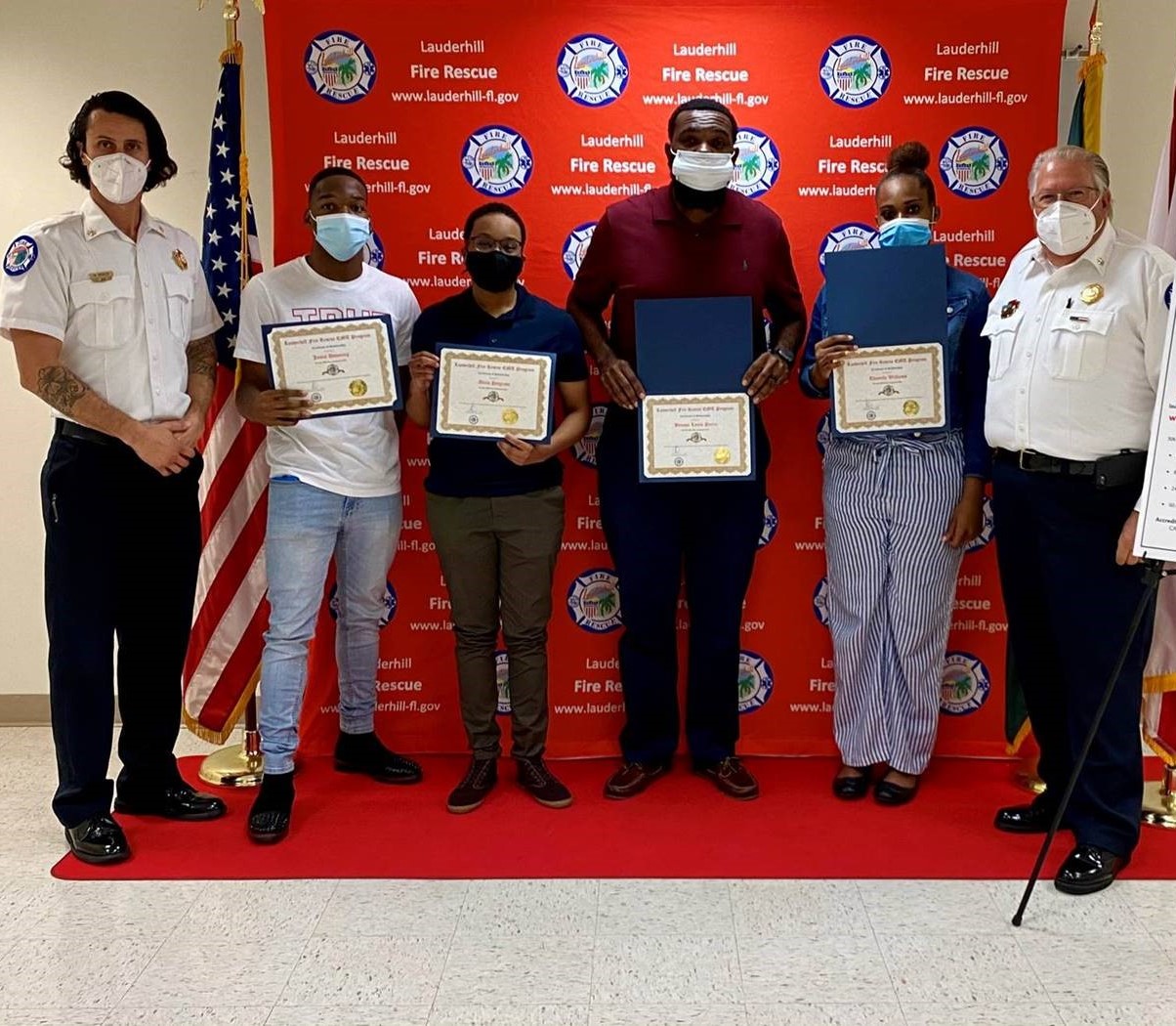 Division Chief Ricardo Morley Jamal Downing holding certificate Alicia Petgrave holding certificate Benson Louis Pierre holding certificate Thanelle Williams holding certificate and Chief Marc Celetti