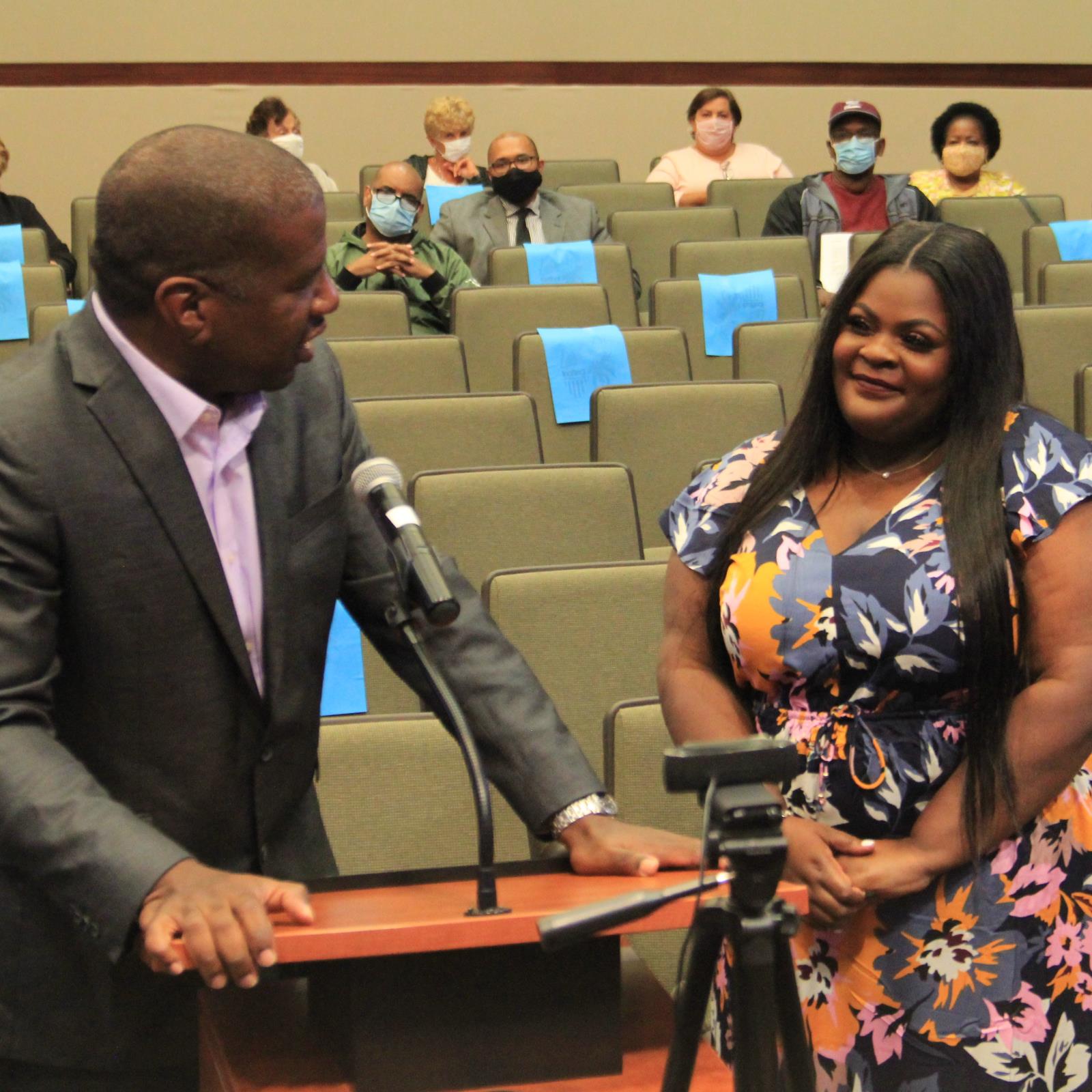 roger Dehart at podium addressing aytia Tarpley to his side at Lauderhill commission chamber