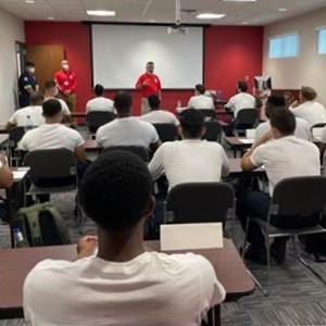 Instructor addressing a room of seated students