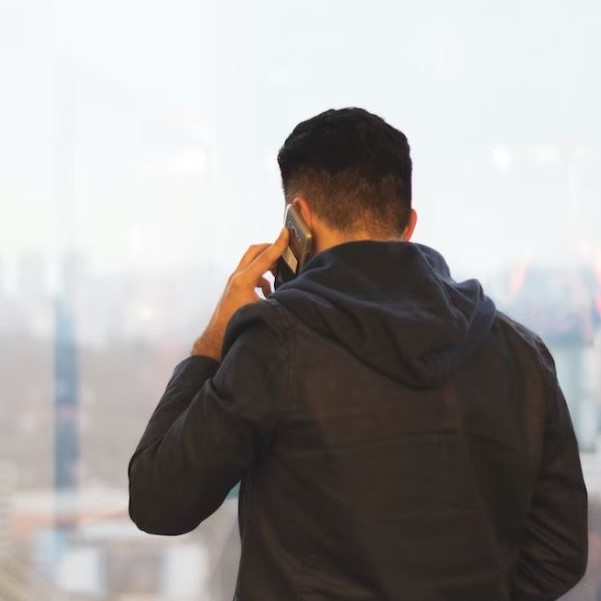 Man on phone with back turned